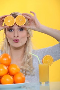 Woman with slices of orange on the forehead
